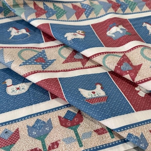 May include: Folded fabric with a repeating pattern of blue, red, and beige squares. The squares feature images of a rocking horse, duck, and chicken. The fabric also has a border of tulips and geometric shapes.
