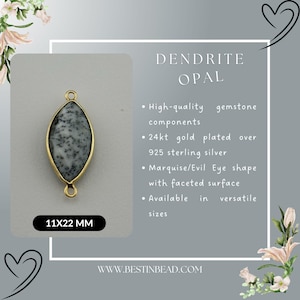 May include: A gold-plated silver pendant featuring a dendrite opal gemstone in a marquise shape. The pendant measures 11mm by 22mm.  The opal has a white and gray color with black dendrite inclusions.  The pendant is available in various sizes.