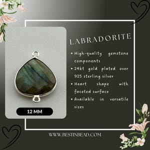 May include: A silver heart-shaped pendant with a 12 mm labradorite gemstone. The pendant is 24 karat gold plated over 925 sterling silver. The gemstone has a faceted surface. The pendant is available in various sizes.  "LABRADORITE" and "WWW.BESTINBEAD.COM" are printed on the image.