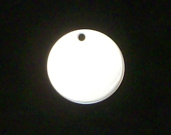 May include: A round, silver-colored metal tag with a hole at the top. The tag is blank and ready to be personalized.