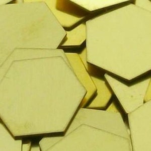 May include: A pile of unfinished, light brown wooden hexagon shapes.