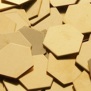 May include: A pile of off-white hexagonal ceramic tiles.