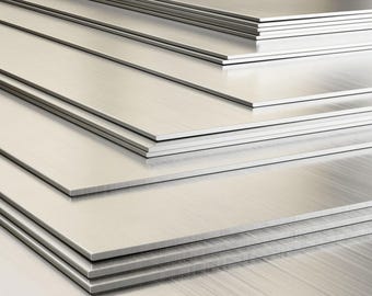 May include: A stack of several brushed metal sheets, each with a reflective, silver surface. The sheets are neatly arranged, with visible grain and texture. The image highlights the clean lines and metallic sheen of the material.