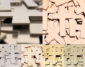 May include: A collection of wooden crosses in various shades of white, beige, and gold. The crosses are of different sizes and are scattered, creating a textured and layered effect. The image is well-lit, highlighting the details of the wood grain.