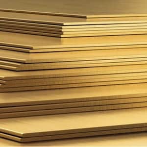 May include: A stack of rectangular, golden-colored metal sheets. The sheets are neatly arranged, with visible edges and a smooth, reflective surface. The image showcases the texture and color of the metal, suggesting a material for crafting or construction.
