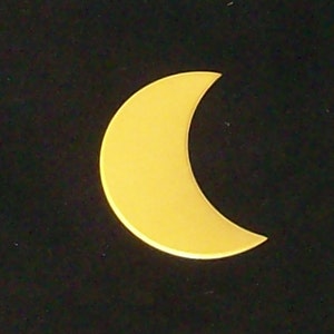 May include: A yellow crescent moon shape against a black background.