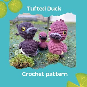 May include: Crochet pattern for a tufted duck. The pattern includes three ducks, one brown and two pink. The ducks are sitting on a bed of moss.