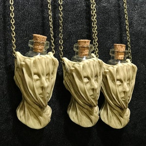 Veiled lady potion pendant by Thomas Kuntz