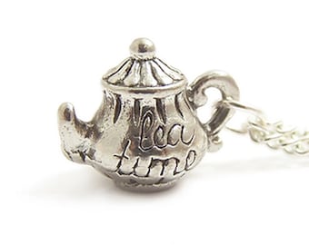 May include: A silver teapot necklace with the words "tea time" engraved on the side.