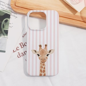 May include: A white and pink striped phone case featuring a giraffe illustration. The giraffe has a brown spotted neck and a light brown face with large eyes. The case has a cutout for the camera.