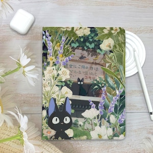 May include: A black and white illustration of a black cat with blue ears, surrounded by white and purple flowers. The text on the sign reads "道に ご用の 方は ベルを 鳴らして コキリ".