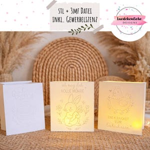 Puede incluir: Tres portavelas blancos iluminados con temática de Pascua. Uno presenta un diseño de huevo en relieve y las palabras "Frohe OSTERN". Otro muestra un conejito con una zanahoria y el texto "ich mag dich VOLLE MÖHRE". El tercero tiene una gallina y el texto "EINE KLEINIGKEIT VOM Osterhasen".