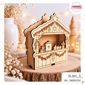 May include: A light-coloured wooden laser-cut structure shaped like a market stall, featuring engraved holiday decorations including a star, heart, and gingerbread man. The front panel displays a counter with mugs and a pot, framed by garlands.