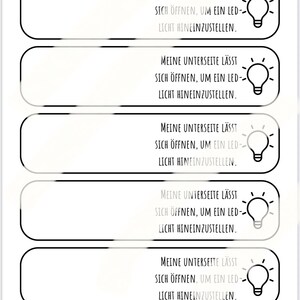 May include: A series of five white rectangular labels with rounded corners, each featuring the text "MEINE UNTERSEITE L&Auml;SST SICH &Ouml;FFNEN, UM EIN LED-LICHT HINEINZUSTELLEN." and a lightbulb graphic.