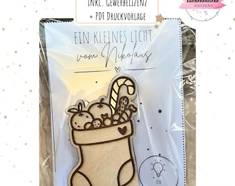 May include: A wooden Christmas stocking ornament filled with candies and fruit, with the text "EIN KLEINES LICHT vom Nikolaus". The ornament is 3mm thick and includes the text "ICH LEUCHTE".