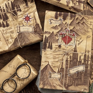 May include: Wrapped gifts with a vintage map design, tied with twine. Some gifts have name tags like "George", "Molly", and "Fred". A pair of round glasses and pine cones are also visible, suggesting a special occasion or holiday.