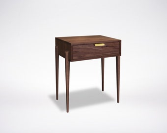 May include: A dark brown wooden nightstand with a single drawer and a brass pull. The nightstand has four slender legs.