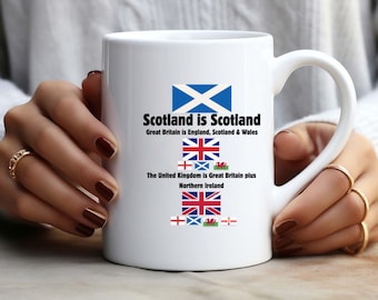 May include: White ceramic mug featuring the text "Scotland is Scotland" with the Scottish flag and other UK flags. The mug also includes the text "Great Britain is England, Scotland & Wales" and "The United Kingdom is Great Britain plus Northern Ireland."