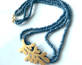 Handmade blue seed bead necklace with gold-plated leafy charm - Nature-inspired jewelry for everyday elegance