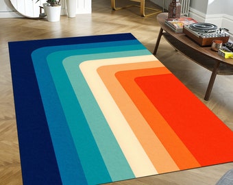May include: A geometric rug with a colorful design featuring a series of blue, teal, cream, orange, and red stripes that form a diagonal pattern.