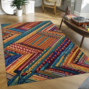 Peut inclure: Un tapis géométrique coloré avec un mélange de teintes orange, jaune, bleu et rouge. Le tapis a un design moderne et abstrait avec une variété de motifs et de formes.