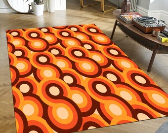May include: A retro-style area rug with a repeating pattern of orange, brown, and cream concentric circles.