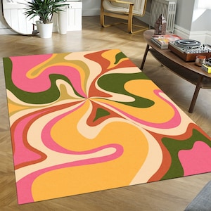 Puede incluir: Alfombra abstracta con un patrón de remolino en tonos de rosa, amarillo, verde y marrón.