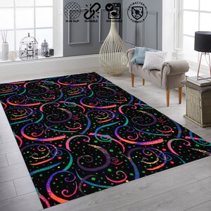 May include: A black area rug with a colorful swirl pattern. The rug has a black background with swirls of pink, blue, green, and yellow. The rug is decorated with small white dots.