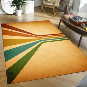 May include: A vintage-style rug with a faded, textured background and a design of colorful stripes converging in the center. The stripes are in shades of brown, orange, yellow, green, and blue.