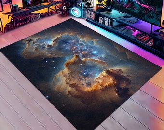 May include: A dark blue rug with a nebula pattern featuring swirling clouds of orange, yellow, and white against a dark blue background with scattered white stars.