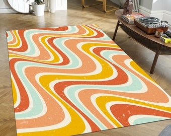 May include: A rectangular area rug with a retro wavy pattern in shades of orange, yellow, light blue, and white. The rug has a distressed, vintage look, adding a touch of nostalgia to any room. The design is reminiscent of the 1970s.