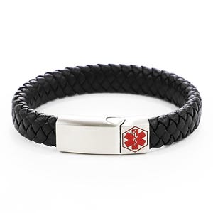 May include: Black leather bracelet with a silver clasp and a red medical symbol.