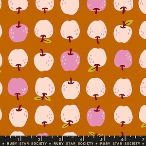 May include: A repeating pattern of stylized apples in shades of pink and white with green leaves and brown stems on a dark orange background. The text "RUBY STAR SOCIETY" is at the bottom.