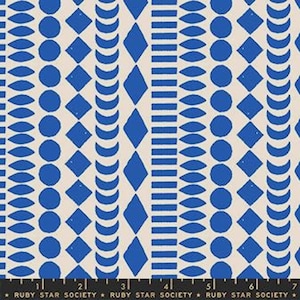 May include: A fabric with a repeating pattern of blue geometric shapes on a cream background. The design includes circles, diamonds, and curved lines. The fabric is from Ruby Star Society.