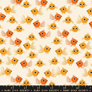 May include: A cream-colored fabric featuring a repeating pattern of small orange goldfish with large black eyes and flowing fins. A black ruler at the bottom edge displays the text Ruby Star Society and measurements in inches from 1 to 7.