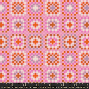 May include: A fabric swatch featuring a repeating grid pattern of squares in shades of pink, orange, white, and light purple. A black ruler at the bottom shows measurements in inches, with the text Ruby Star Society printed repeatedly along the edge.