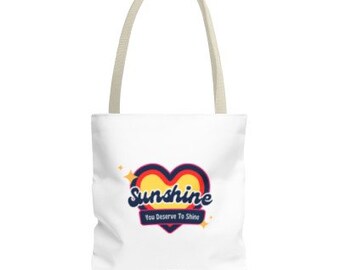 Peut inclure: Sac fourre-tout blanc avec un motif de cœur coloré et le texte "Sunshine You Deserve To Shine".