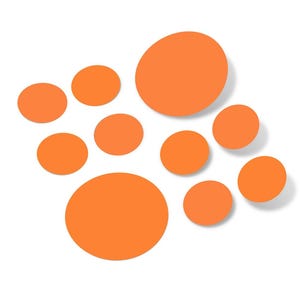May include: An assortment of orange circular shapes of varying sizes are arranged against a white background. The circles appear to be flat and solid, with a slight shadow suggesting they are raised.