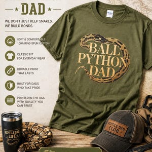 May include: An olive green t-shirt with the text "BALL PYTHON DAD" and a graphic of a ball python. The image also shows a black tumbler, a baseball cap with "REPTILE DAD CLUB" on it, and a sign that says "PROUD DAD. PROUD PYTHON KEEPER."