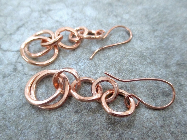 <img src=“earrings.jpg" alt="Boho style long drop earrings with hand forged copper chain link dangles of interlocking rings"