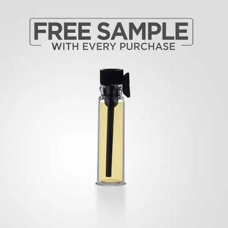 May include: A clear glass sample bottle with a black cap and a black applicator stick. The bottle contains a yellow liquid. The text "FREE SAMPLE WITH EVERY PURCHASE" is displayed above the bottle.