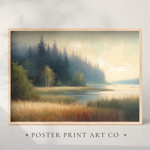 May include: A framed painting depicting a misty forest scene with a lake in the foreground. The trees are a dark green and the water is a light blue. The sky is a soft yellow with the sun shining through the trees.
