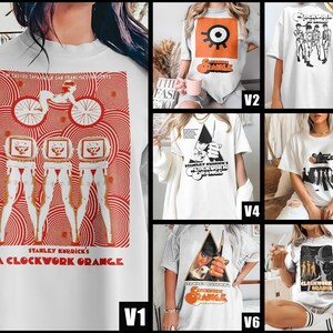 May include: White t-shirts with various graphic designs inspired by the film "A Clockwork Orange." The designs include the film's title, characters, and iconic imagery in orange and black. The shirts are short-sleeved.