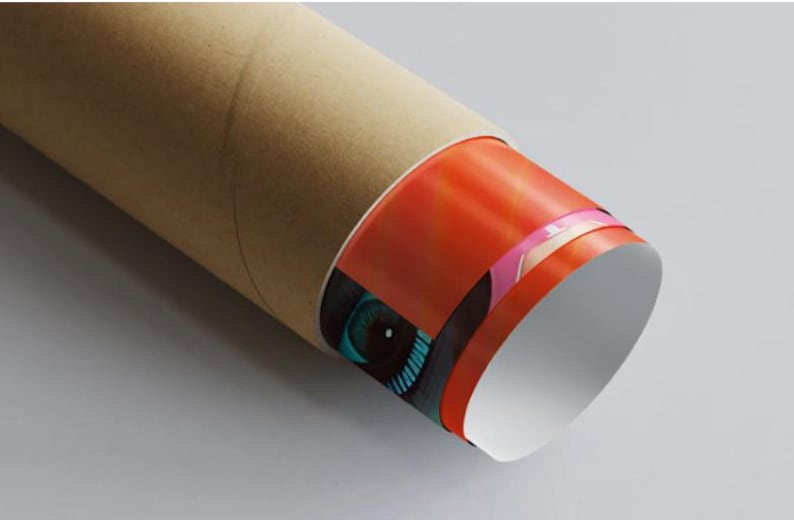 May include: A rolled-up poster with a vibrant design, partially visible. The visible portion features a close-up of an eye with teal iris and black surrounding details. The poster is encased in a brown cardboard tube.