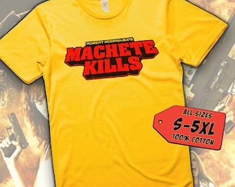 May include: Yellow t-shirt featuring the text "ROBERT RODRIGUEZ'S MACHETE KILLS" in red and black. The shirt includes a tag indicating sizes S-5XL and is made of 100% cotton.