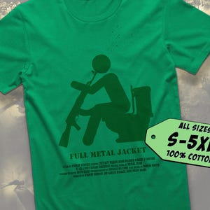 May include: Green t-shirt featuring a dark green silhouette of a person on a toilet, holding a rifle. The words "FULL METAL JACKET" are below the image, with more text underneath. A green tag shows sizes S-5XL and 100% cotton.