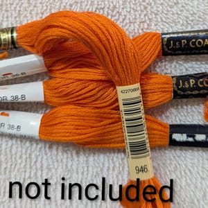 May include: Several spools of bright orange embroidery floss are arranged on a white surface. Some spools are labeled "COLOR 38-B" and "J. & P. COATS". The text "DMC not included" is visible at the bottom of the image.