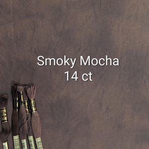 May include: A piece of Smoky Mocha 14 ct fabric with several skeins of matching embroidery floss. The fabric is a solid, muted brown color. The text "Smoky Mocha 14 ct" is displayed in white. The floss is a similar shade of brown.