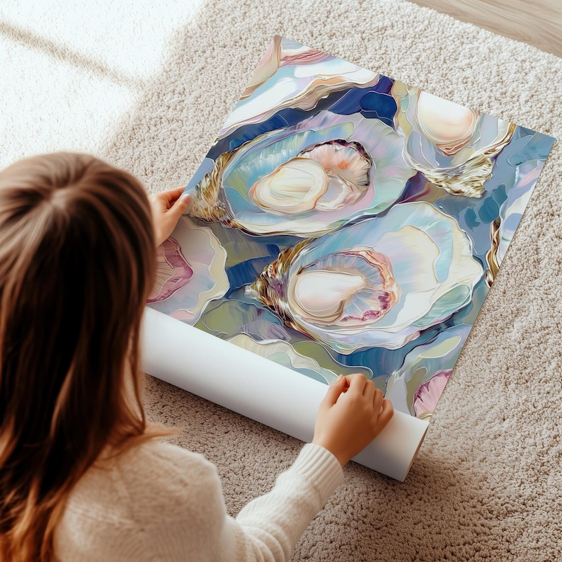 May include: A rolled-up art print featuring an oyster shell design in shades of blue, white, and pink. The artwork has a painterly style with soft edges and highlights. The print is being unrolled on a light-colored carpet.