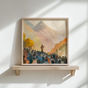 May include: A framed watercolour painting showing a crowd of people gathered before a figure on a hill. The background features mountains and a warm colour palette of oranges, yellows, and blues. The artwork is displayed on a wooden shelf.